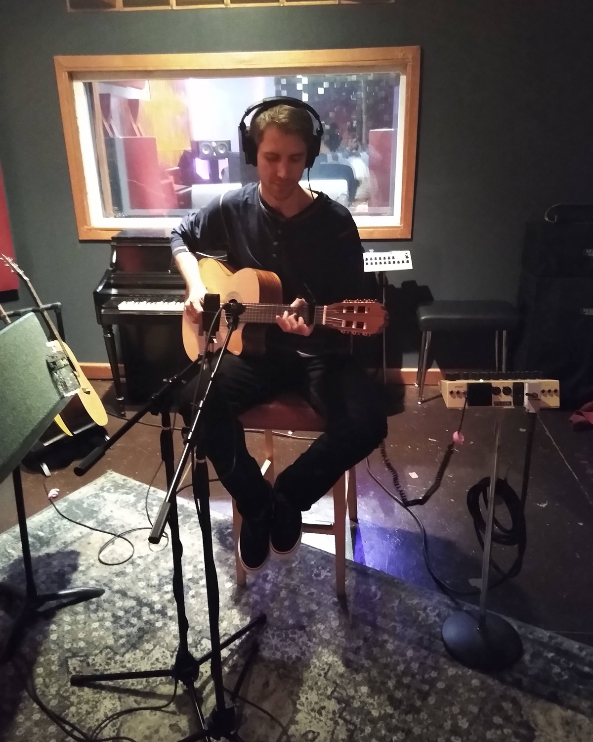 Samuel Pickens tracking acoustic guitar in a live room